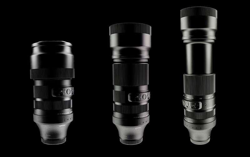 Three telephoto lenses arranged in order of increasing length against a black background.