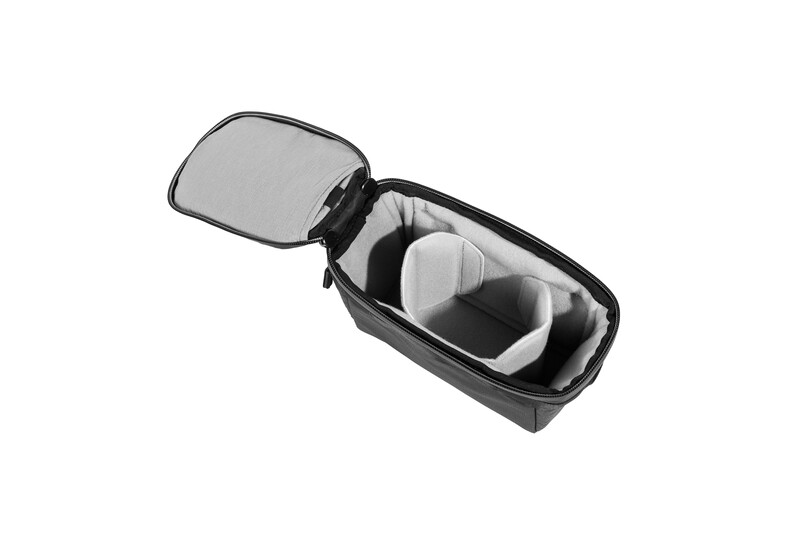 Open camera equipment bag with padded dividers and compartments in black and gray.