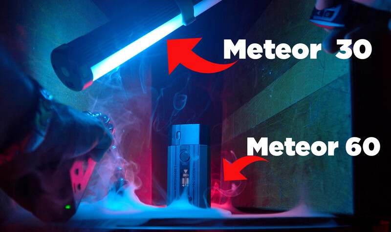 Comparison shot of two Meteor lighting fixtures labeled Meteor 30 and Meteor 60 in a studio setting with blue and red neon gel lighting.