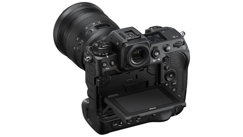 Professional mirrorless camera with attached telephoto lens and battery grip, shown from rear three-quarter angle.