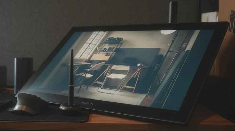 Tablet displaying architectural rendering of interior space with chairs and natural light.