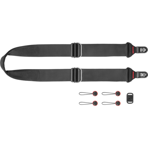 Camera shoulder strap system with two black straps, connectors, and accessories laid out.
