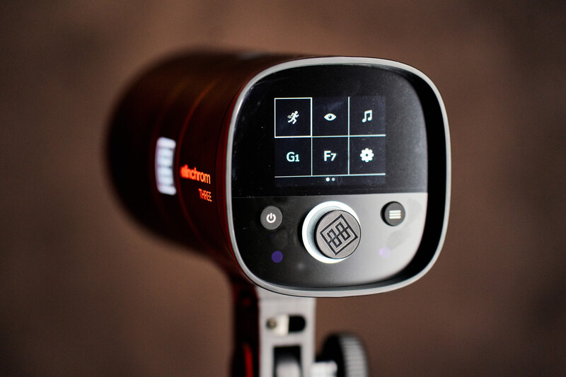 Close-up of a camera-mounted light meter's control panel with buttons and a touchscreen display.
