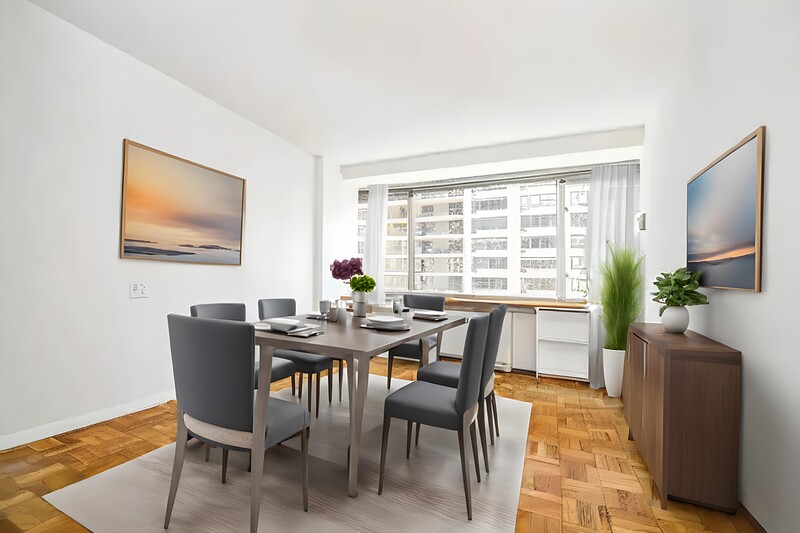 Modern dining room with wooden table, gray upholstered chairs, and large windows overlooking city buildings.