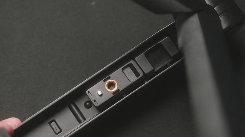 Close-up of a camera's window control panel with buttons and a gold-colored dial.