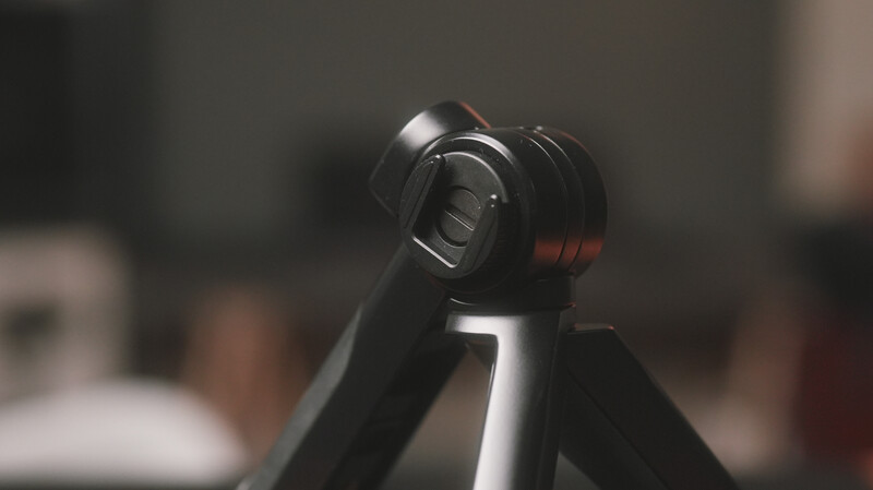 Close-up of a gimbal's motorized head with digital display mounted on a black stabilizing arm.