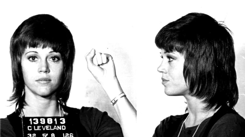 Black and white mugshot showing front and side profile views of a woman with dark hair and bangs.
