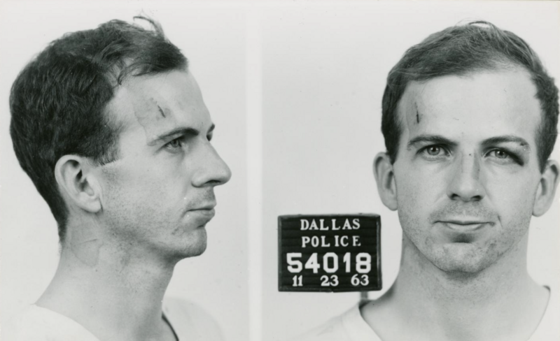 Police mugshot showing side and front profile views of a man with identification placard.