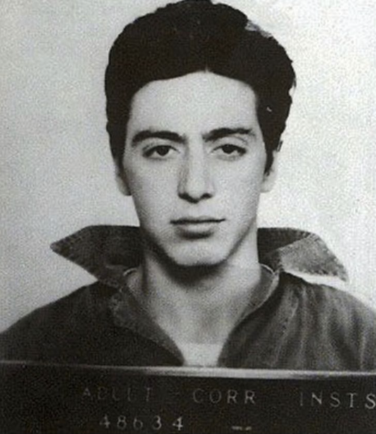 Black and white portrait photograph of a young man with dark hair, institutional mugshot style.