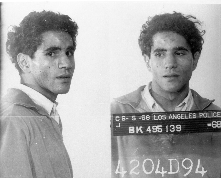 Police mugshot showing profile and front views of a man with identification placard and booking number.