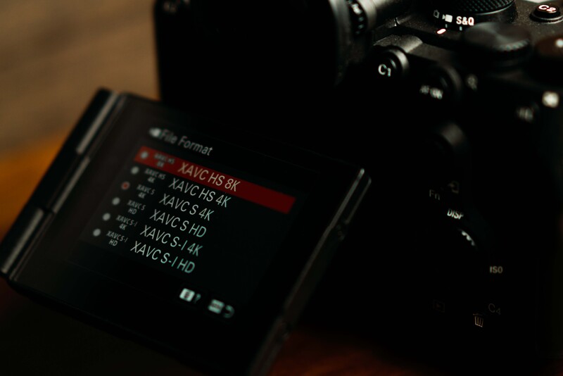Camera viewfinder screen displaying a list of video codec format options in red and white text.