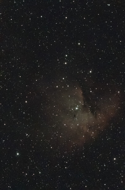 Milky Way galaxy photographed against a dark starfield with dust lanes and bright star clusters visible.