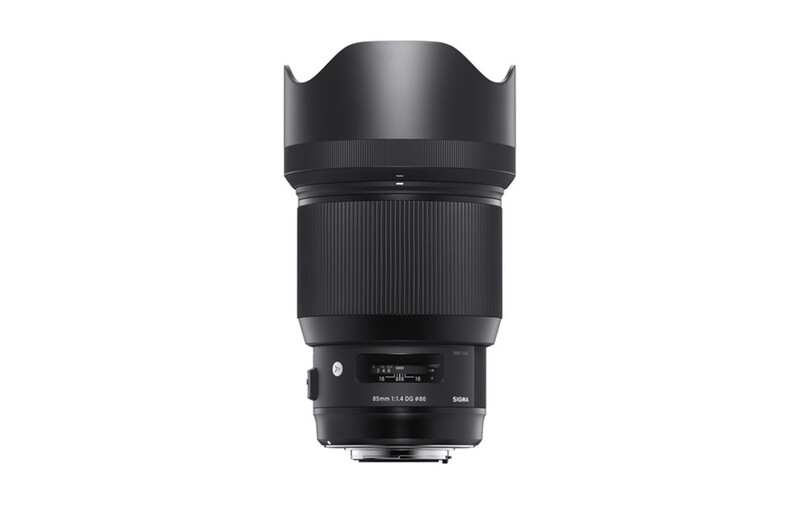 Black telephoto lens with hood and focus ring against white background.