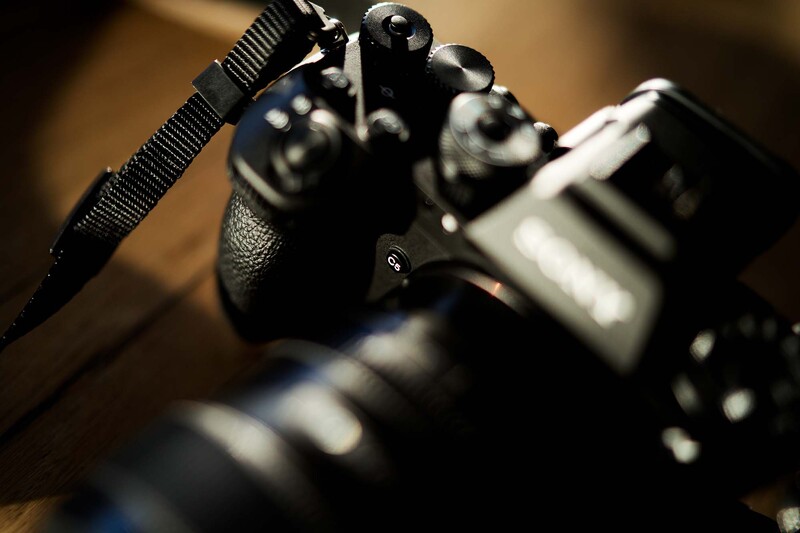Close-up of camera controls with shallow depth of field and warm studio lighting.