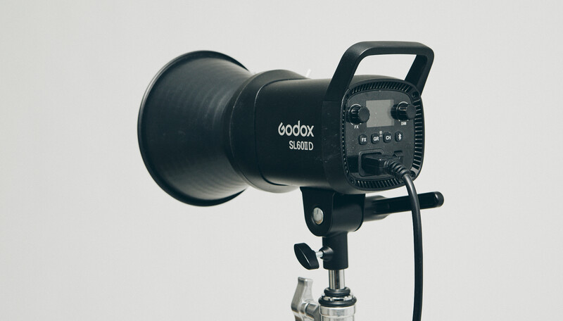 Godox SL60W LED spotlight mounted on a studio stand against a neutral gray background.