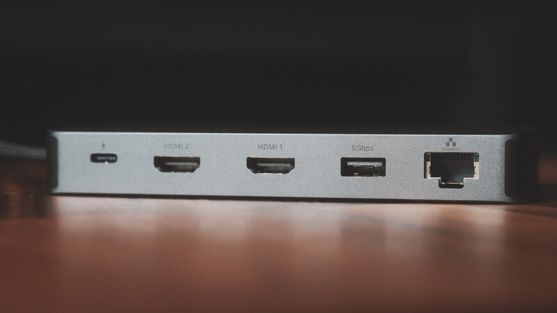 Close-up of a silver device's rear panel showing multiple ports including USB-C, two HDMI inputs, one HDMI output, and an ethernet connection.