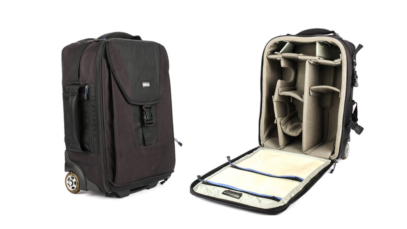 Black rolling camera bag shown closed and open, displaying padded dividers and compartments inside.