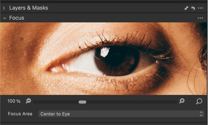 Close-up of a human eye with warm skin tones and visible eyelashes, demonstrating focus and detail in portrait photography.
