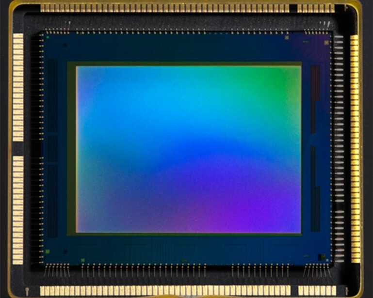 Close-up of a camera image sensor showing a smooth color gradient from blue-green to magenta.