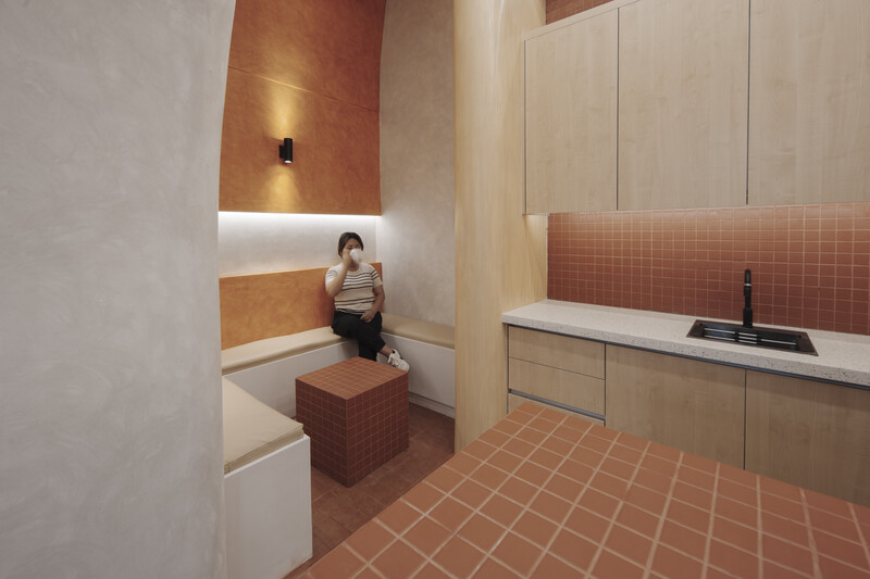 Architectural rendering of a modern bathroom with terracotta tile flooring and warm wood accents.