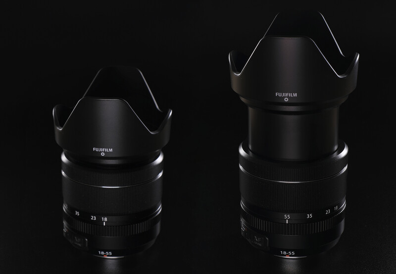Two Fujifilm prime lenses with lens hoods displayed against a black background.