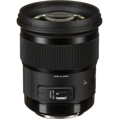 Black telephoto lens with vertical ribbed barrel and control ring on focus motor housing.