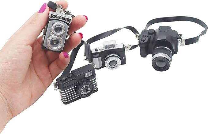 Collection of five vintage film cameras with different formats and sizes displayed together.