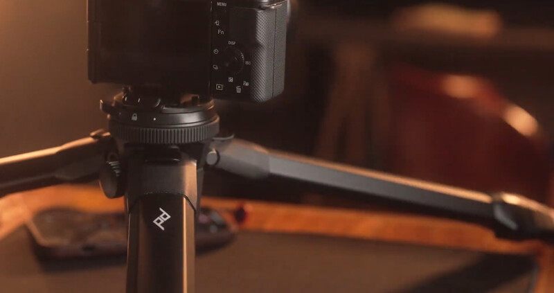Camera mounted on tripod with warm studio lighting illuminating the setup.