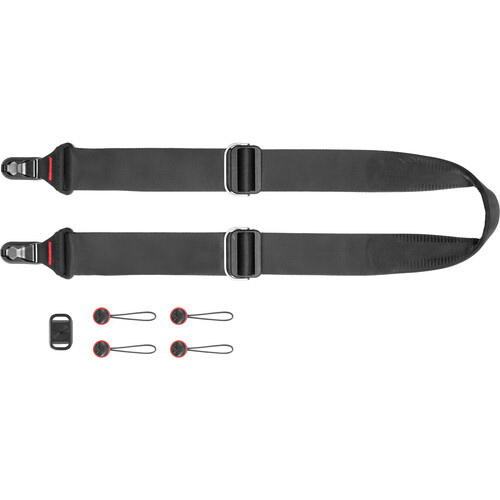 Camera strap with dual attachment points and interchangeable connectors displayed with accessories.