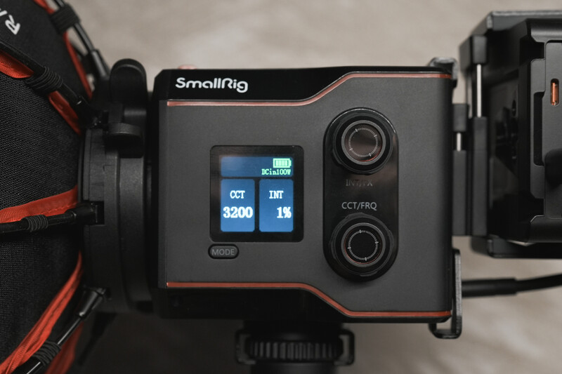 SmallRig camera monitor with dual lens mounts and blue display screen showing CCT and IRE settings.
