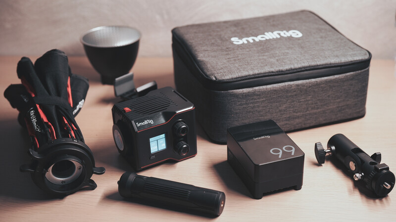 Smartno camera flash kit laid out with modifiers, battery pack, and carrying case.