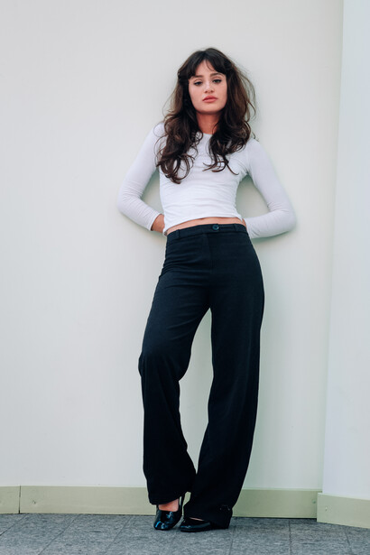 Model standing in front of a white wall.