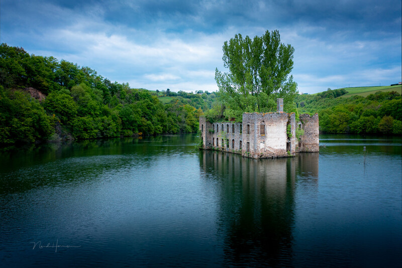 Chateau Grandval in France is situated in a lake that doesn't allow a clear view. Trees are obstructing the view from most places. But a drone can overcome this problem. But you don't have to reach a great altitude for the best composition.
