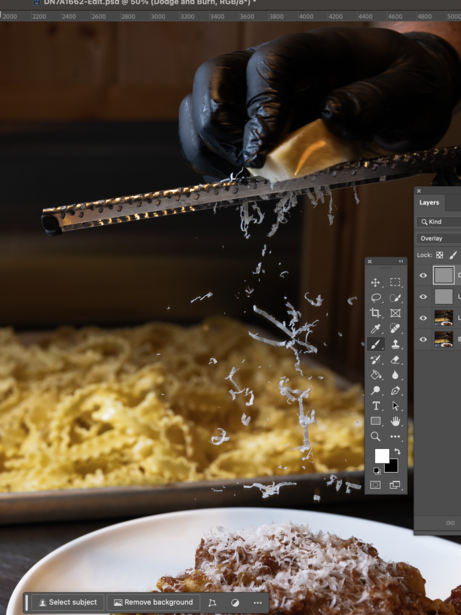 Food photography setup showing a pouring shot captured in post-processing software with a plated dish below.