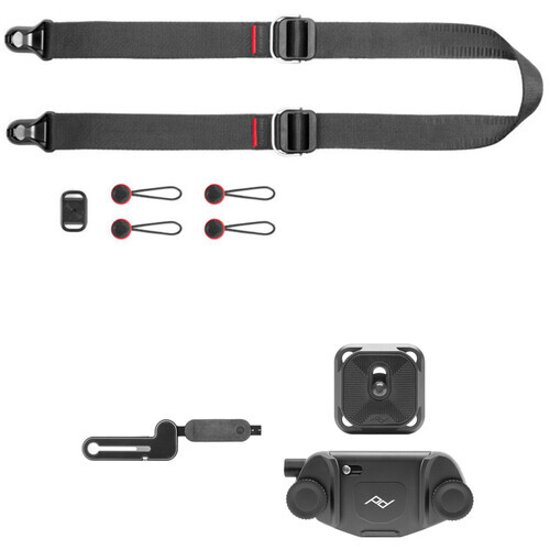 Camera strap system with buckles, attachment points, and mounting accessories laid out flat.
