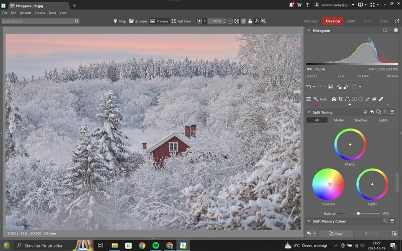 Screenshot of photo editing software showing a snowy landscape with a red cabin among frost-covered trees.
