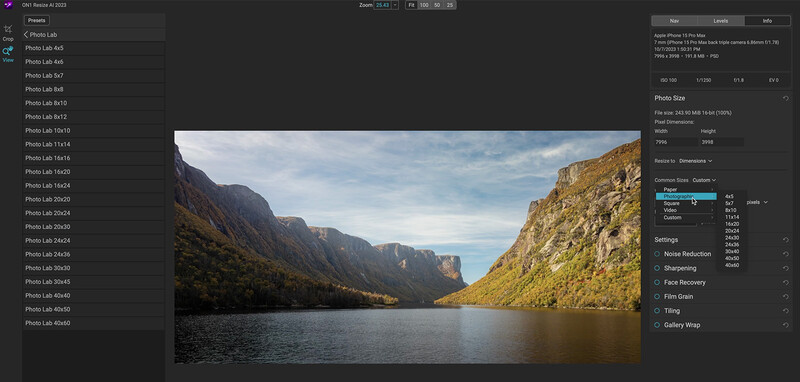 Mountain lake surrounded by steep rocky cliffs under a partly cloudy sky.