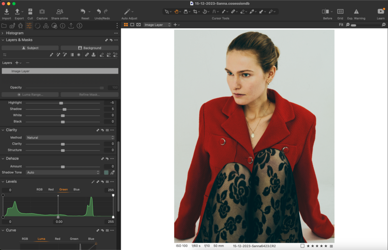 Screenshot of photo editing software showing a portrait of a woman in a red blazer with patterned trim.
