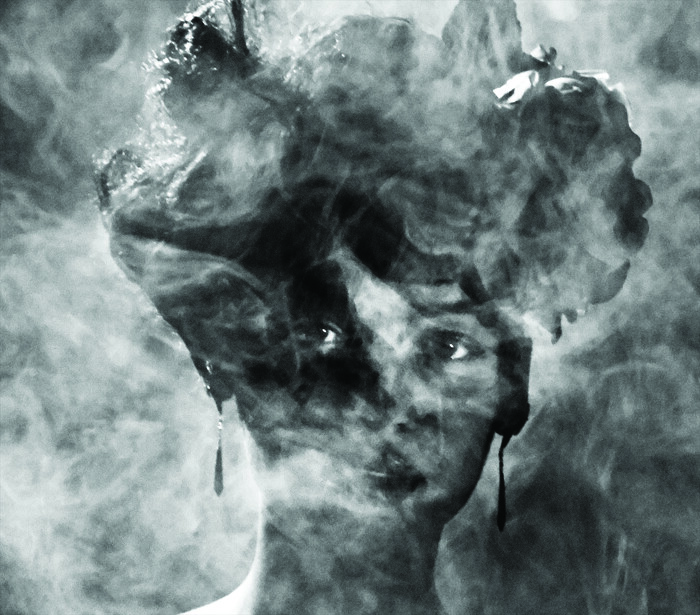 Abstract double-exposure portrait merging a woman's face with stormy cloud formations and atmospheric textures.