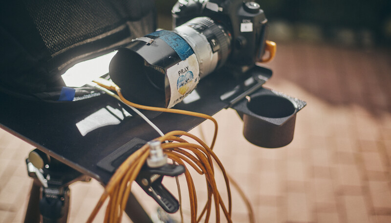Professional video lighting setup with a softbox and coiled cable connected to camera equipment.