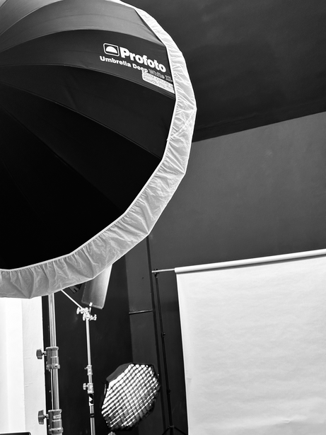 Large circular softbox with diffusion panel mounted on studio lighting equipment.