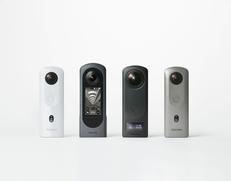 Four compact cylindrical cameras arranged in a line, featuring white, dark gray, black, and light gray finishes.