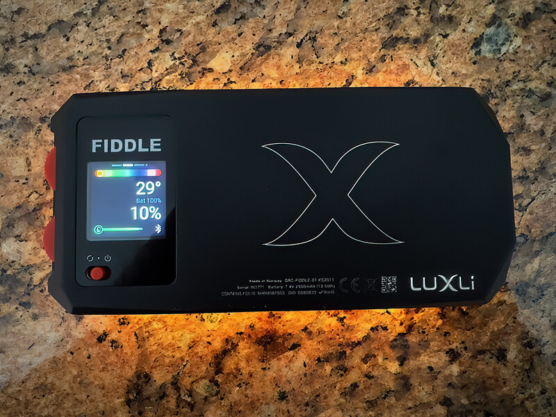 Luxi Fiddle light meter displayed on granite surface, showing 29° color temperature and 10% reading on small screen.