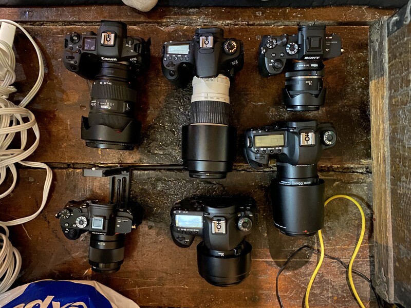 Canon and Sony cameras on a table