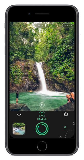 Screenshot of smartphone camera app displaying a waterfall composition with lush green foliage.