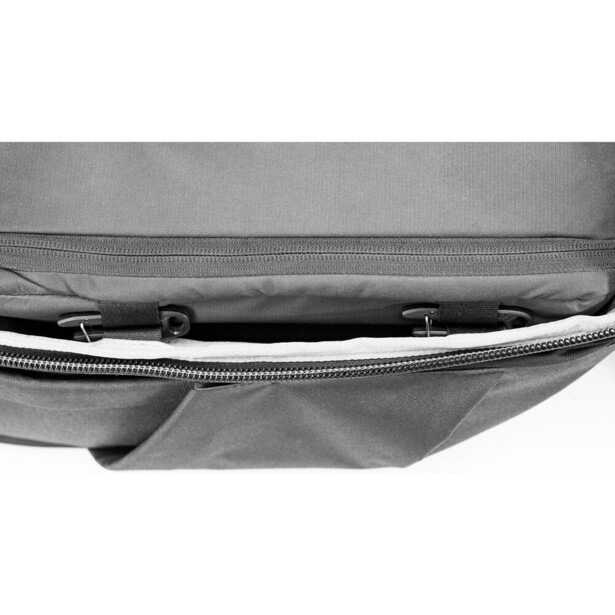 Close-up of a gray fabric camera bag's zipper and interior compartment detail.