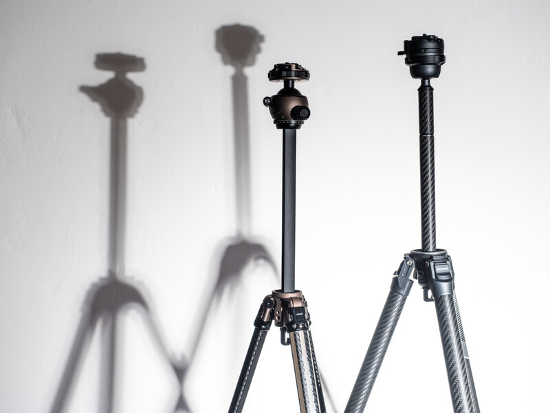 Four tripod stands arranged in a row, displaying various head styles and leg designs with dramatic shadows on white background.
