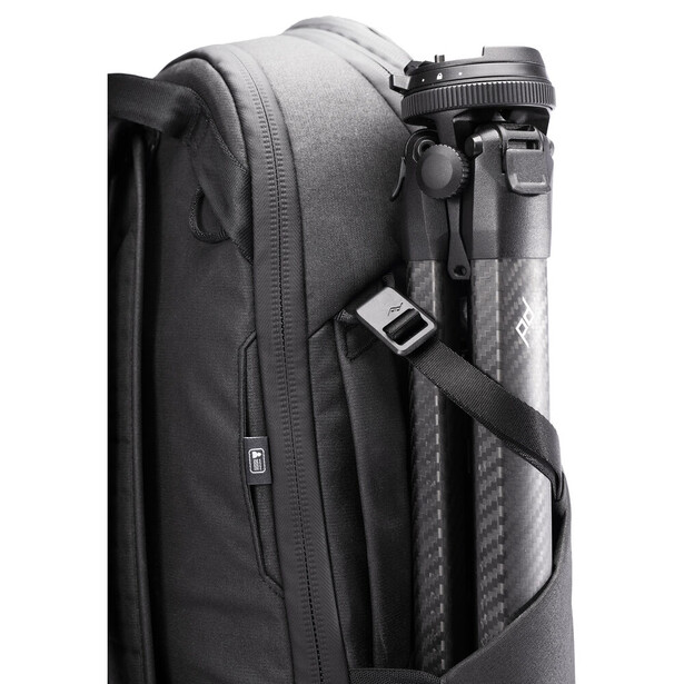 Dark gray camera backpack with attached tripod and padded side compartment.