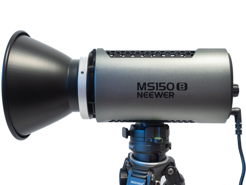 Neewer MS150B monolight mounted on a blue ball head tripod with reflector attached.