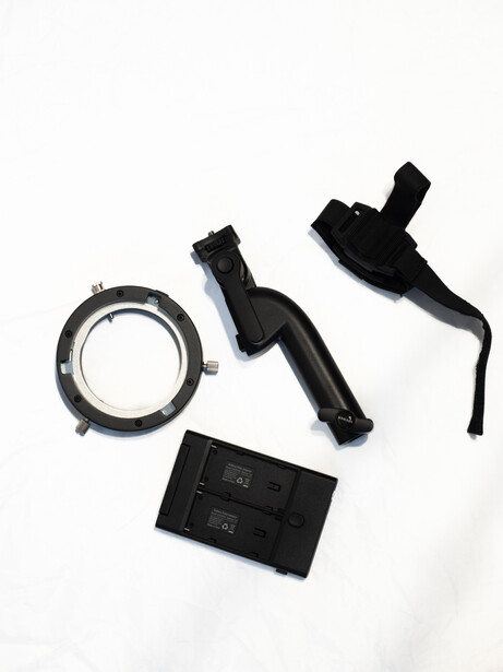 Disassembled camera flash components laid out flat against white background.